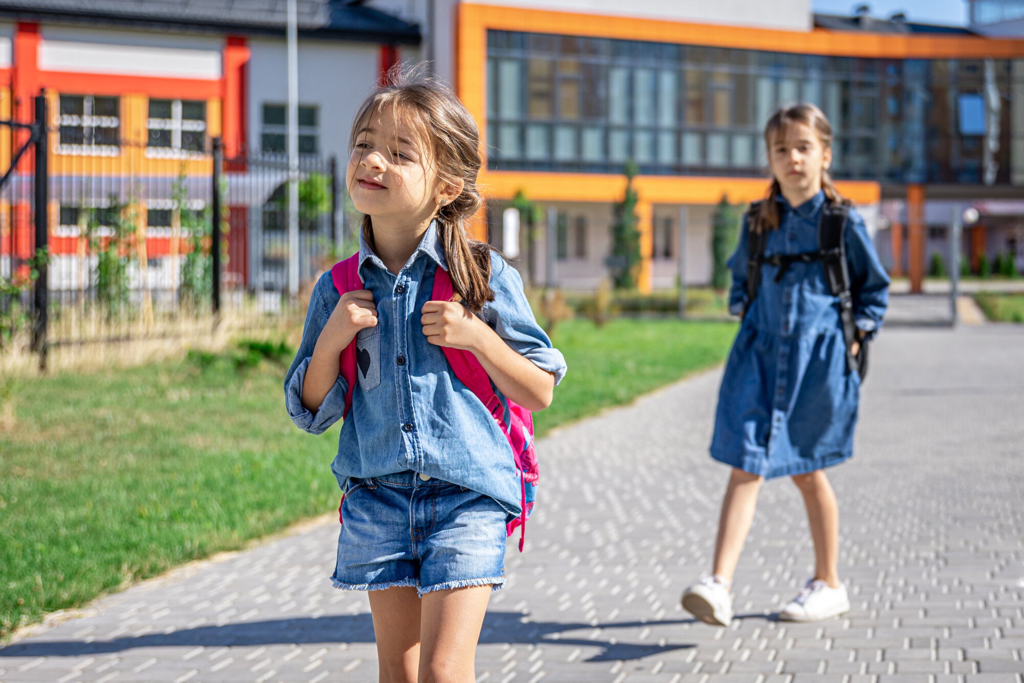 pupils-primary-school-girls-with-backpacks-near-school-outdoors-beginning-lessons-first-day-fall pupils-primary-school-girls-with-backpacks-near-school-outdoors-beginning-lessons-first-day-fall